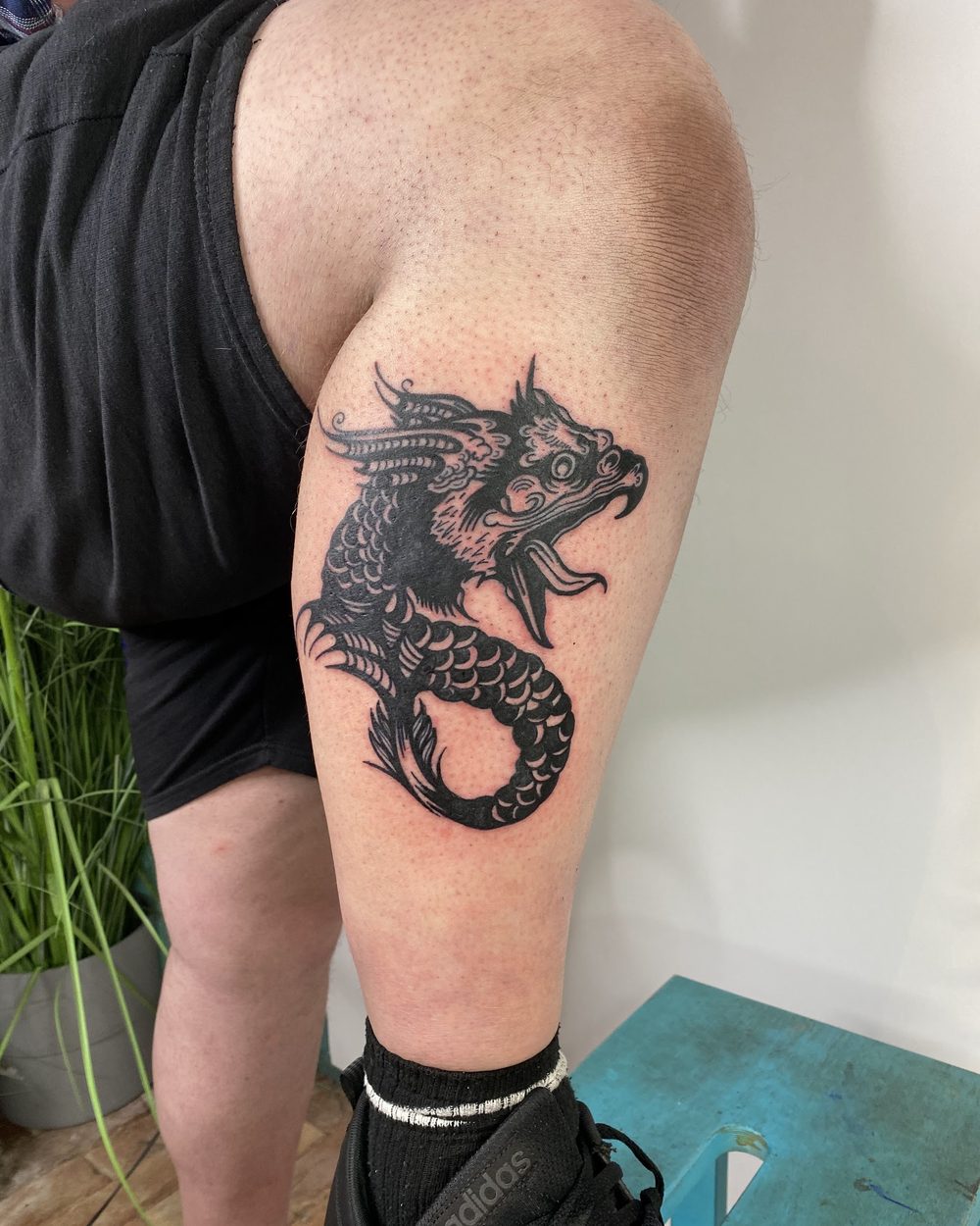 Hound in blackwork on the outside of a thigh