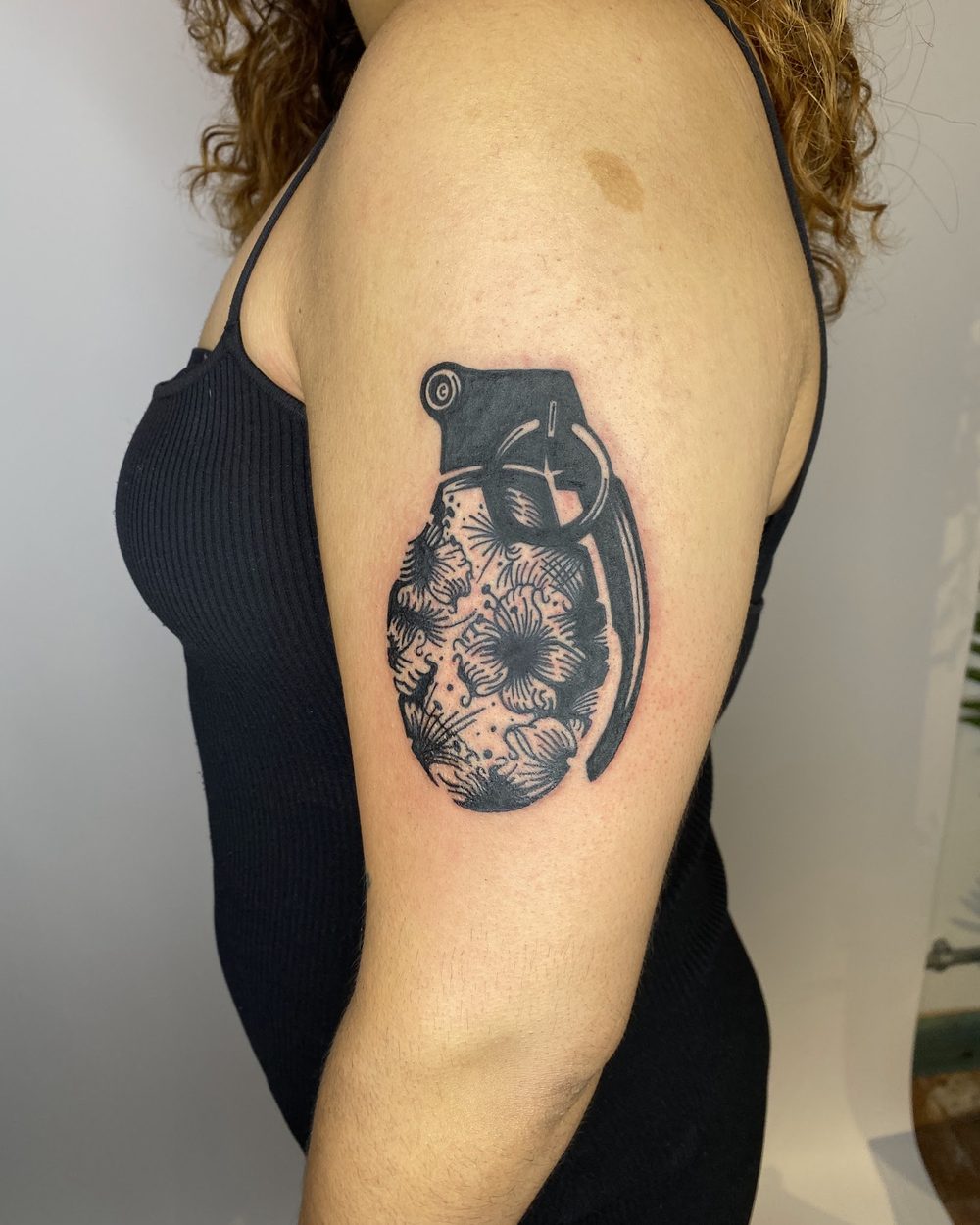 Woman's head woven into flowers on a hip