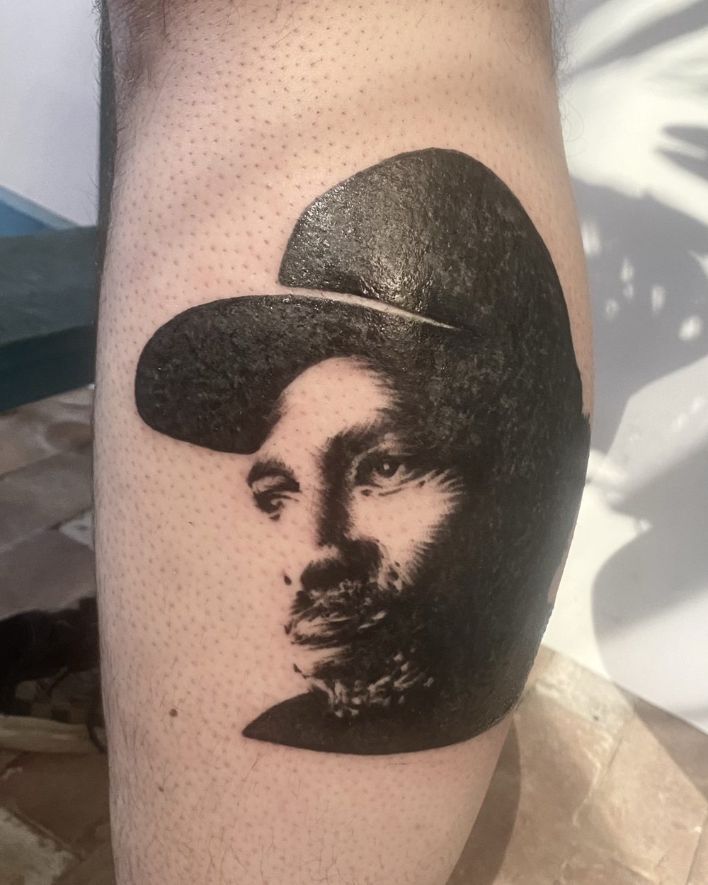 Grenade rendered in illustrative blackwork on an upper arm