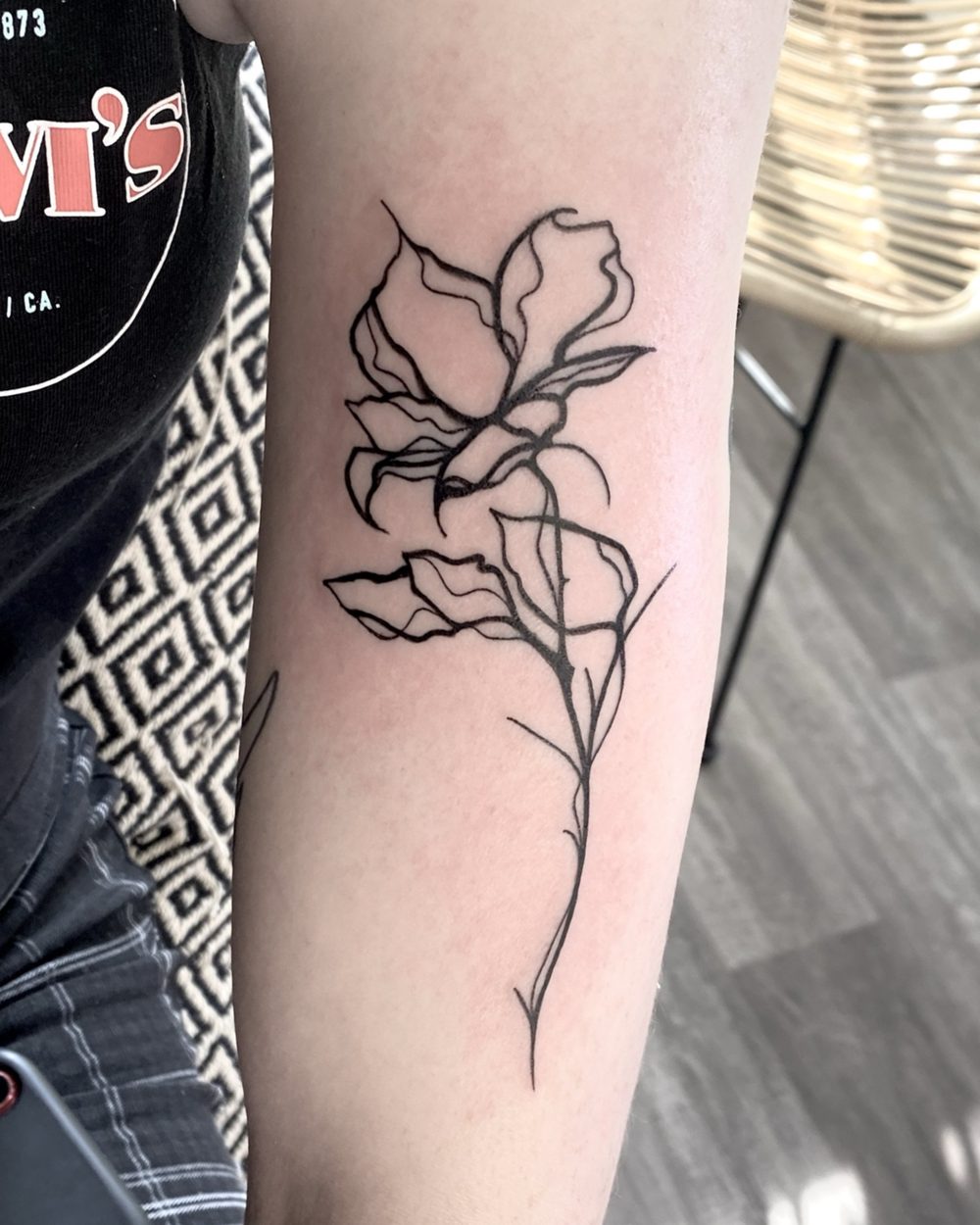 Heart-shaped balloon tattoo on the front of an ankle