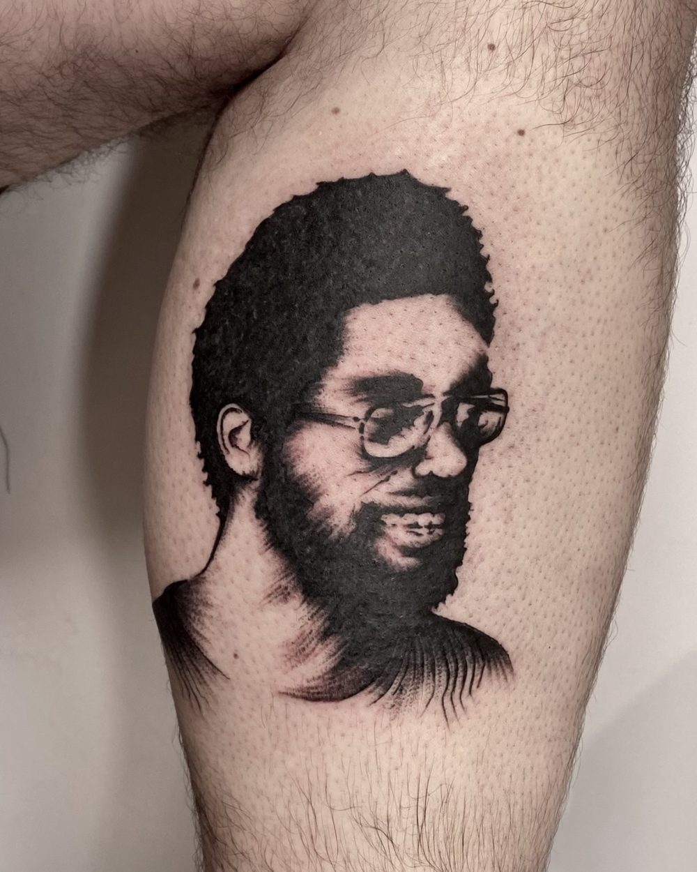 Portrait framed inside a solid black cap shape on a calf