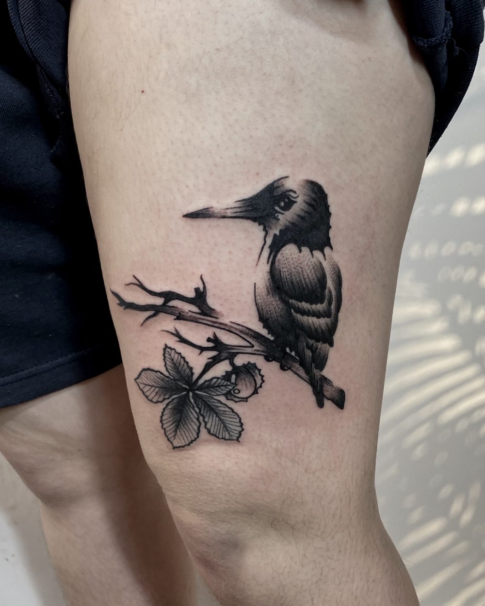 Single-line rose stem drawn down a forearm