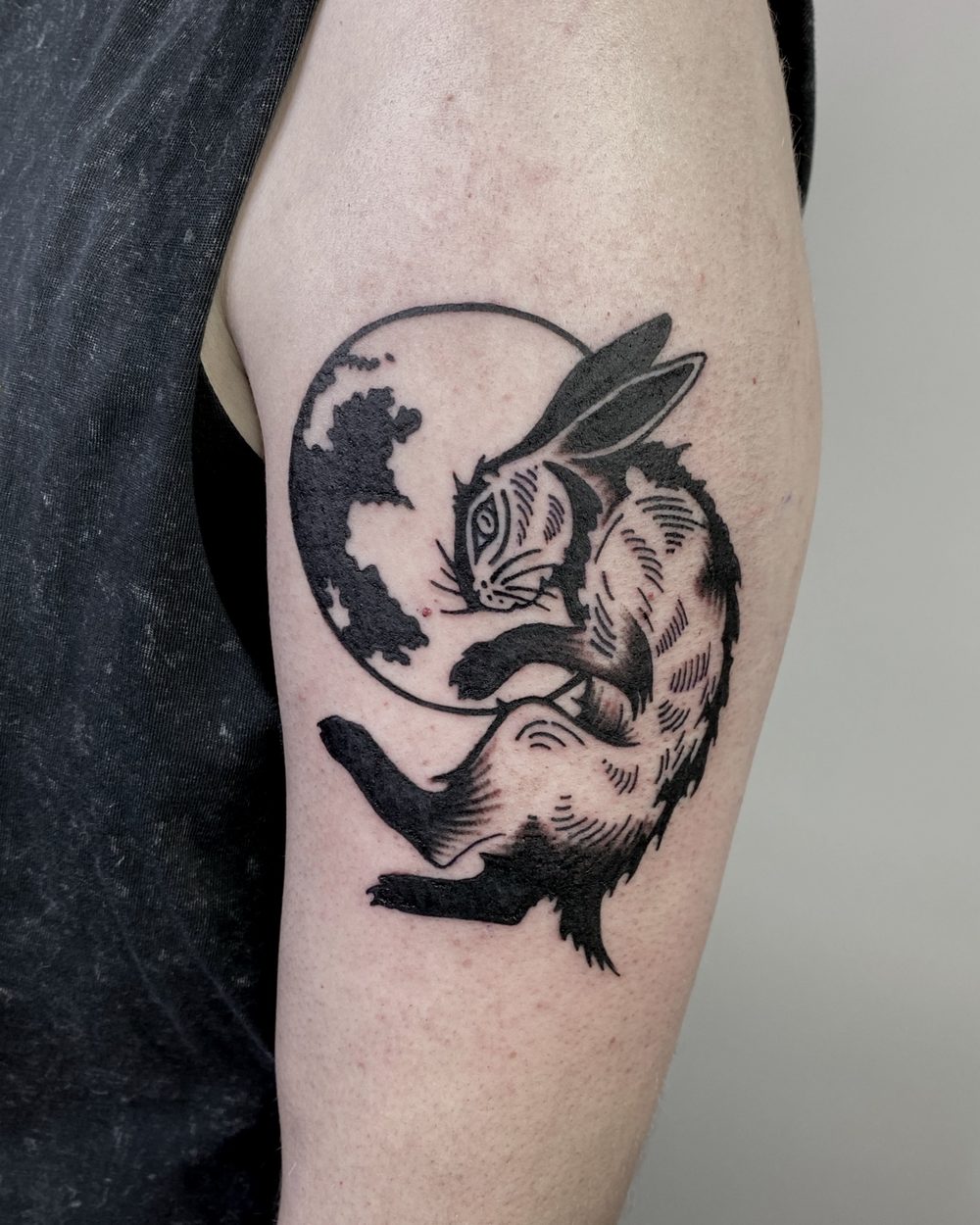 Eagle and serpent locked together across a ribcage